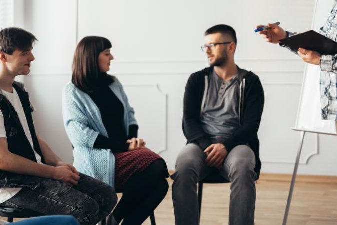 therapist-stands-in-front-of-a-group-of-people-of-2024-10-22-12-10-33-utc